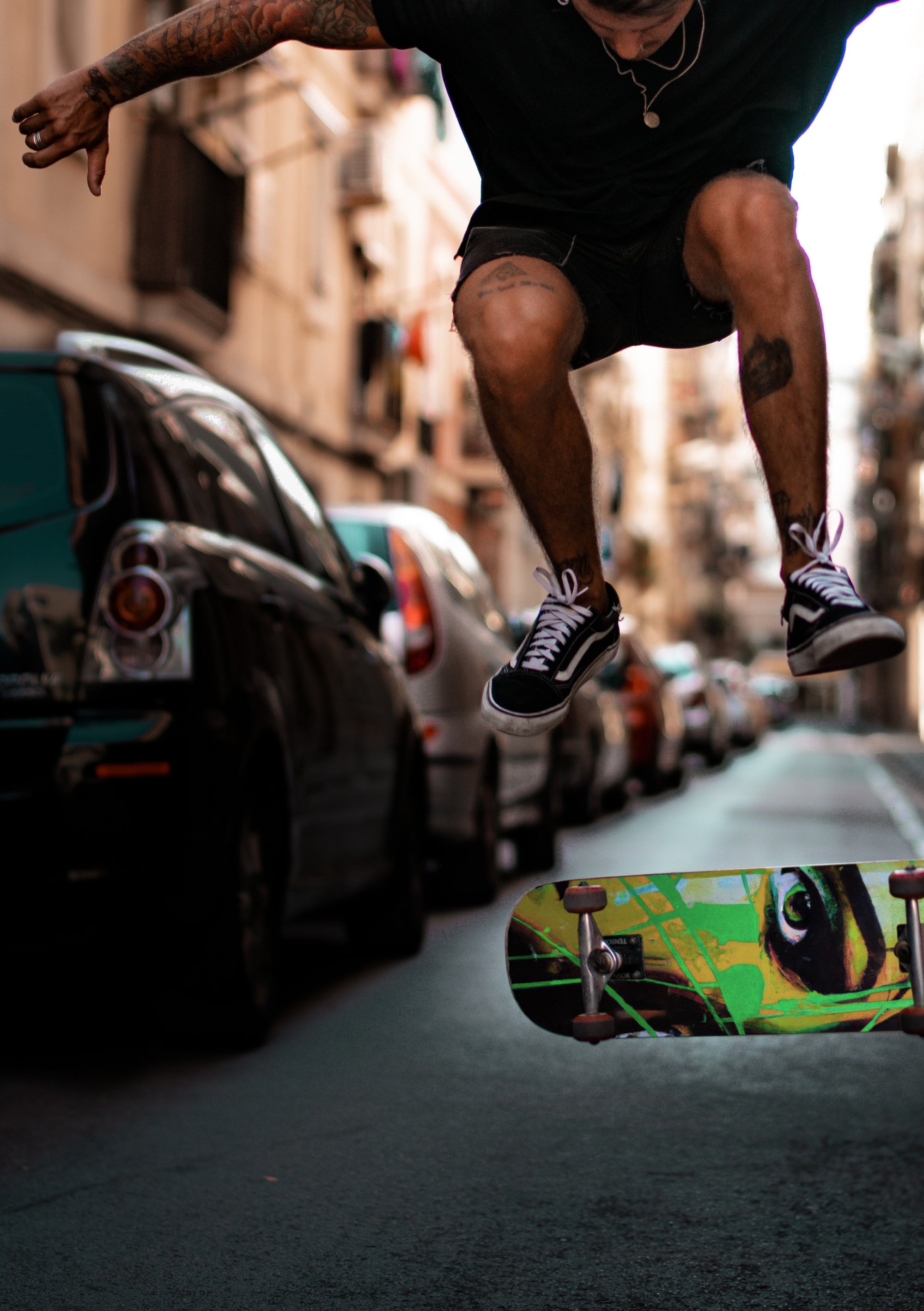 A man doing a skateboard trick in the street