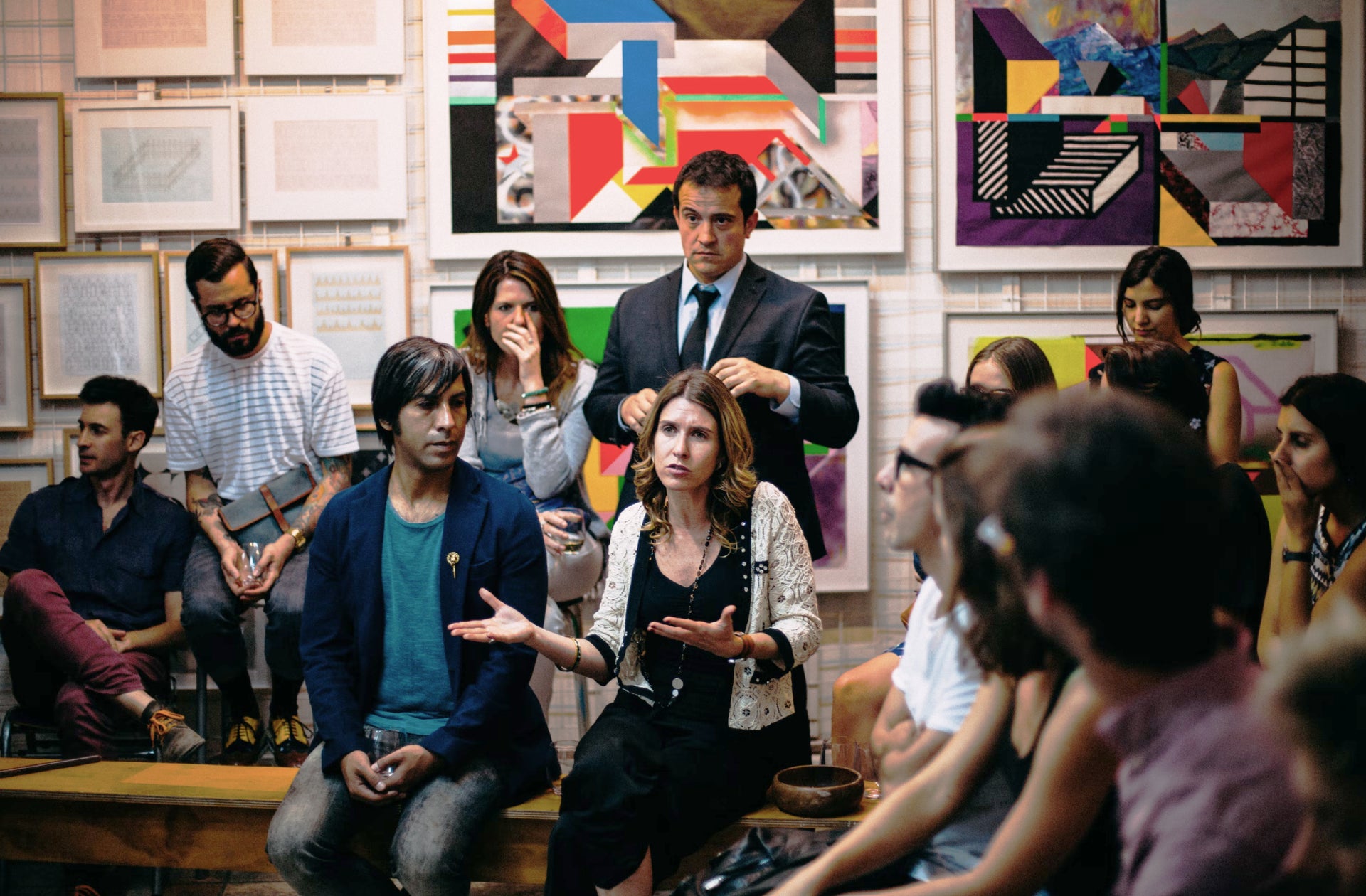 A group of people in an art studio having a conversation