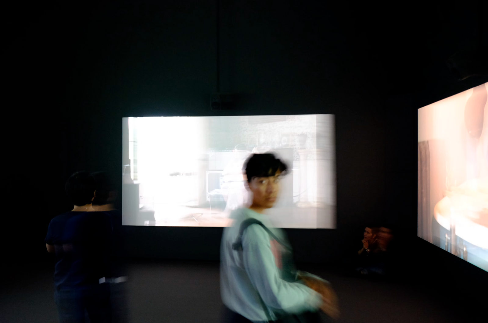 A woman walking in an art exhibition