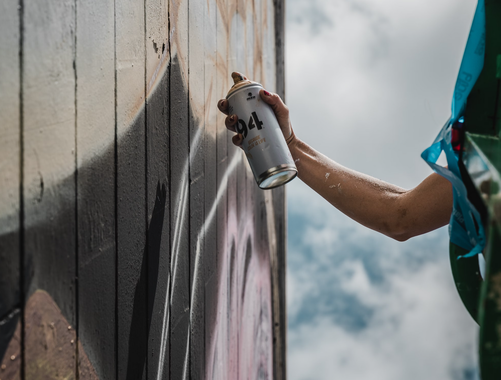 Somebody painting a wall with spray paint