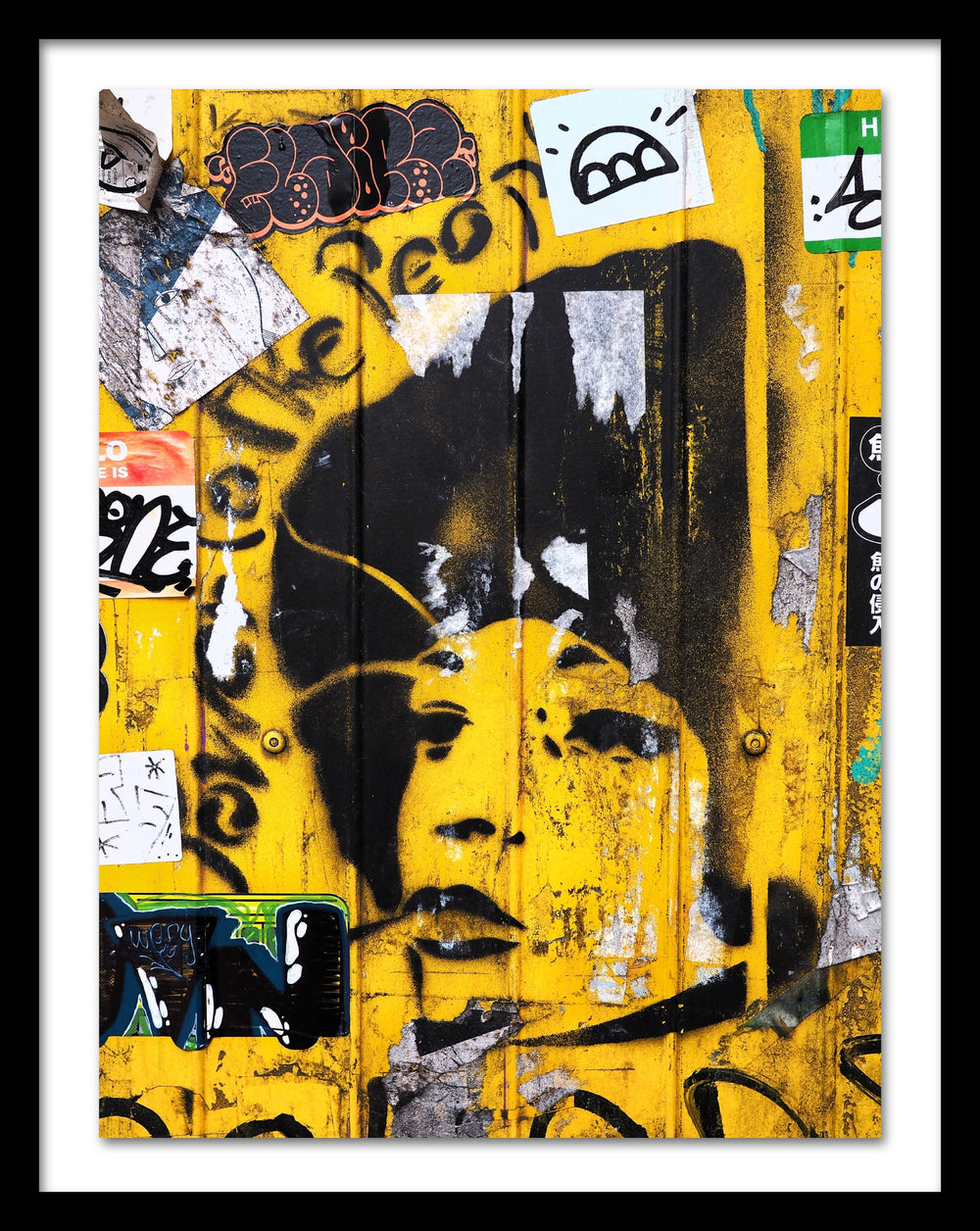 A poster that depicts the portrait of a woman painted with a stencil over a yellow wall